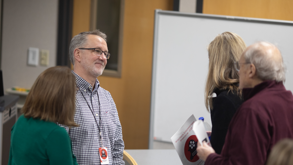 Symposium attendees network together. 
